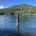 Calm water and a solitary wooden post, a quiet image reflecting scripture about perfect peace